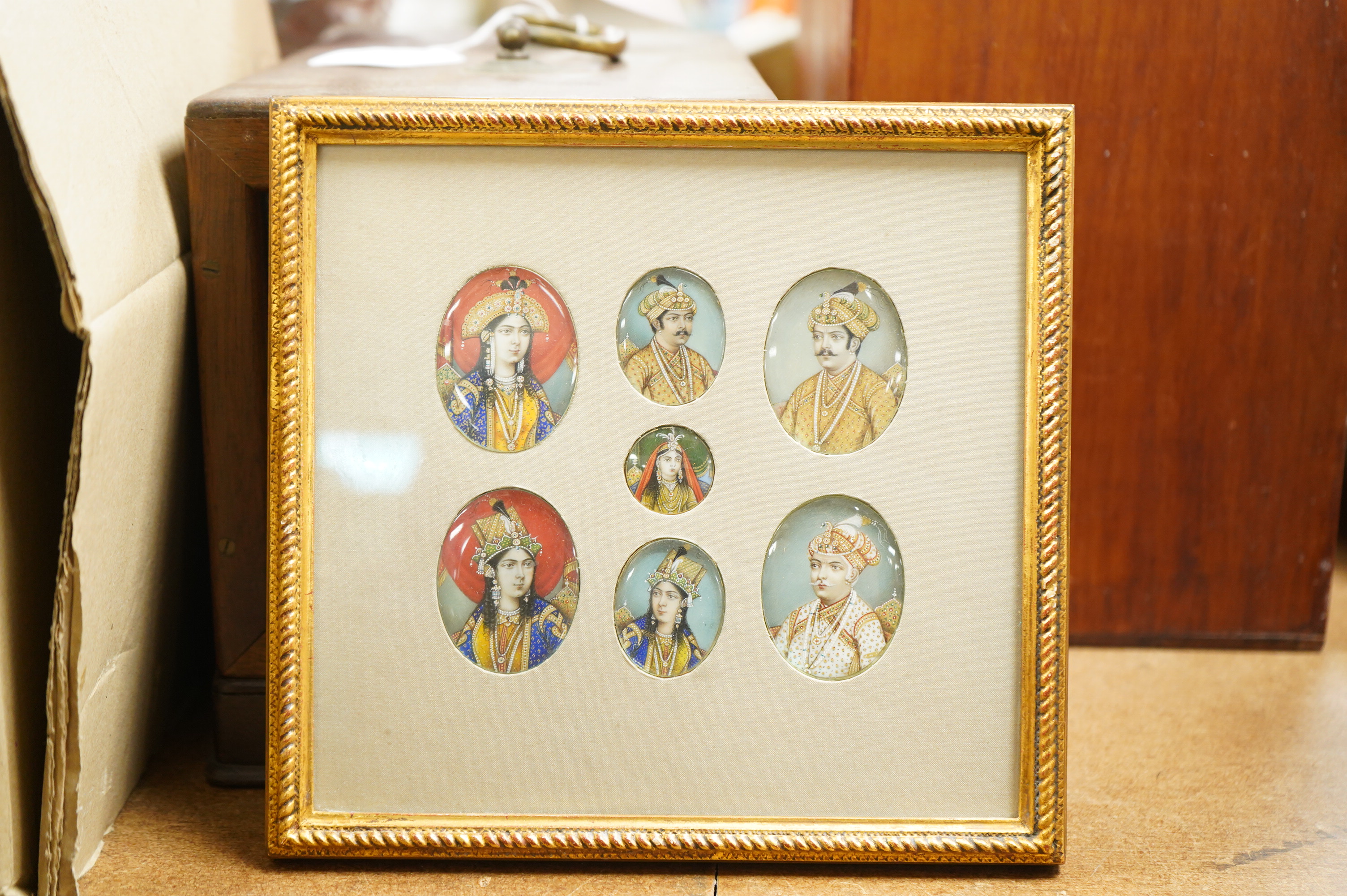 Indian School, 19th century, a set of seven family portrait miniatures, oils on ivory, mounted and framed as one, largest miniature 5 x 3.5cm CITES Submission reference, NGUHCSRQ